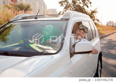sea vacation car travel concept man in scuba mask driving car full of bags sea vacation car travel concept man in scuba mask driving car full of bags 100546256