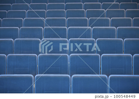 A row of empty chairs in the auditorium of the cinema. A row of empty chairs in the auditorium of the cinema. 100548449
