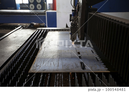 Cutting of metal. Sparks fly from laser.Laser cutting machine working with sheet metal with sparks at factory, plant. 100548481