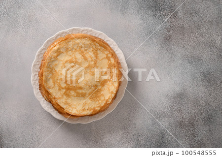 Russian thin pancakes or blini on gray background. 100548555