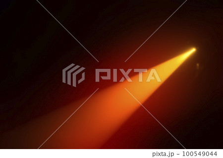 Orange blurred beam of stage light on a dark background. Orange blurred beam of stage light on a dark background. 100549044