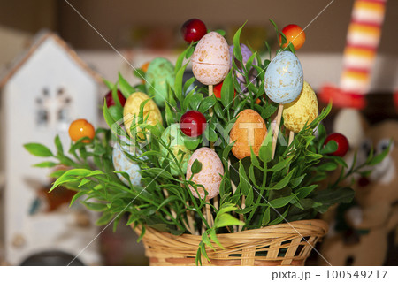 Easter basket with green grass and handmade decorative eggs. 100549217