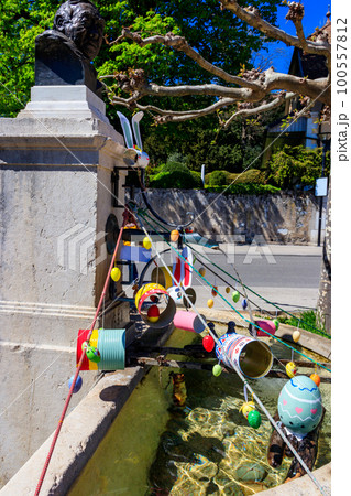 Festive decorations for Easter holiday on the fountain in Nyon, Switzerland 100557812