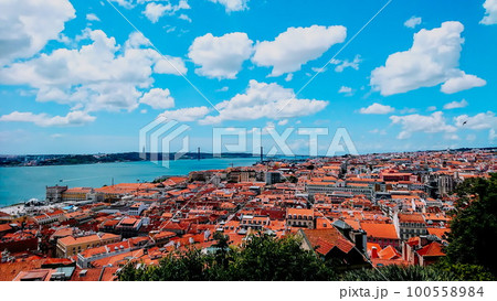 Lisbon, Portugal - June 1, 2018: aerial view of Lisbon landscape under sunlight and blue sky and a bridge in the background Lisbon, Portugal - June 1, 2018: aerial view of Lisbon landscape under sunlight and blue sky and a bridge in the background 100558984