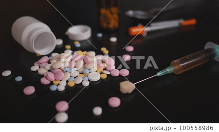 addict's table pills and injection on the black table addict's table pills and injection on the black table 100558986
