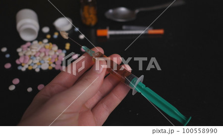addict's table pills and injection on the black table addict's table pills and injection on the black table 100558990