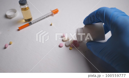 addict's table pills and injection on the black table 100559777