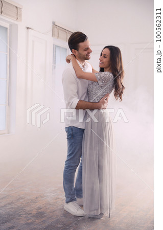 Lovely young couple dancing together in ballroom 100562311