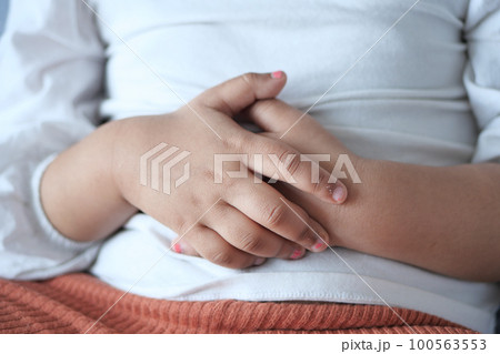 child suffering stomach pain close up. 100563553