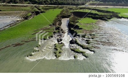 aerial view of underground sinkhole waterfall as water flows 100569108