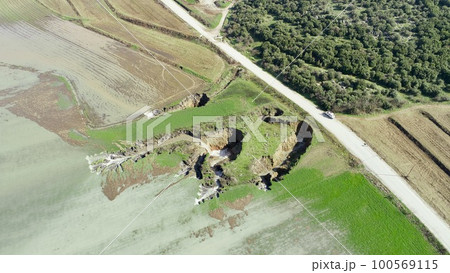aerial view of underground sinkhole waterfall as water flows 100569115