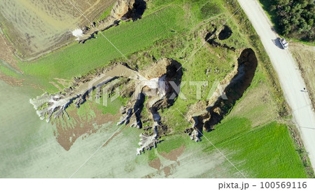 aerial view of underground sinkhole waterfall as water flows 100569116