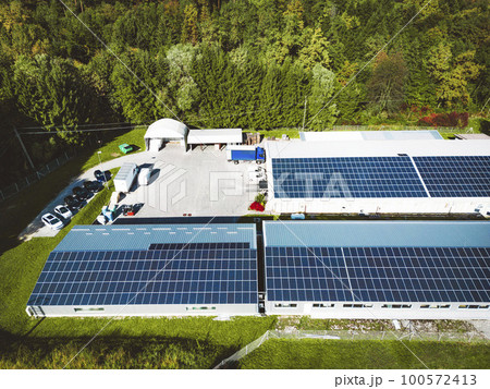 Solar panels on the rood of industrial buildings on a secluded sunny location Solar panels on the rood of industrial buildings on a secluded sunny location 100572413