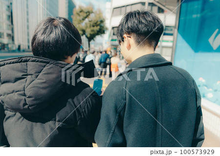 男子大学生が街中で歩いている写真 100573929