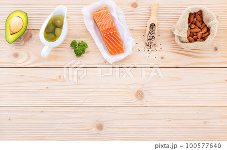 Ketogenic low carbs diet concept. Ingredients for the healthy foods selection setup on wooden background with copy space. Ketogenic low carbs diet concept. Ingredients for the healthy foods selection setup on wooden background with copy space. 100577640