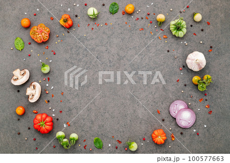 The ingredients for homemade pizza set up on dark stone background. The ingredients for homemade pizza set up on dark stone background. 100577663