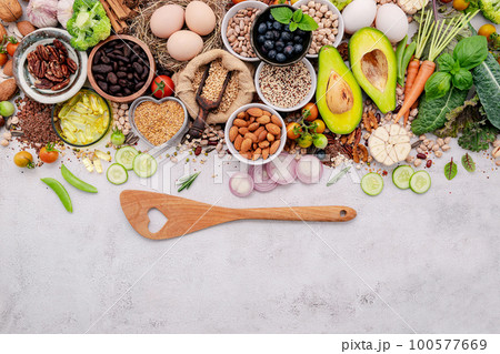 Ingredients for the healthy foods selection. The concept of superfoods set up on white shabby concrete background with copy space. 100577669