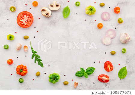The ingredients for homemade pizza set up on white concrete background. 100577672
