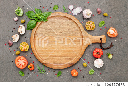 The ingredients for homemade pizza set up on dark stone background. The ingredients for homemade pizza set up on dark stone background. 100577678