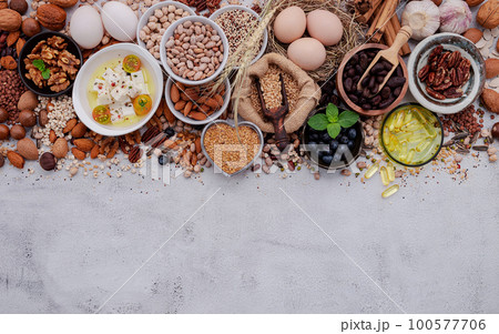 Ingredients for the healthy foods selection. The concept of superfoods set up on white shabby concrete background with copy space. 100577706