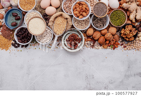 Ingredients for the healthy foods selection. The concept of superfoods set up on white shabby concrete background with copy space. 100577927