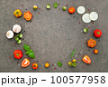 The ingredients for homemade pizza set up on dark stone background. 100577958