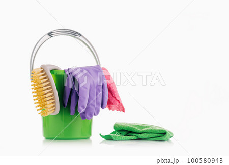Household Cleaner tools and sundry items Spring cleaning kitchen, bathroom and other rooms. on white. Cleaning and janitorial service concept. Green and vibrant violet. Bucket with gloves and dusters 100580943