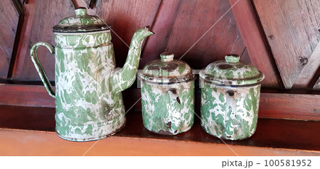 Antique teapot and teacups made of enamel tin called blirik teapots, blirik glasses and blirik teapots for tea, coffee or orange, hot and warm drinks Antique teapot and teacups made of enamel tin called blirik teapots, blirik glasses and blirik teapots for tea, coffee or orange, hot and warm drinks 100581952