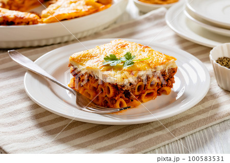 Greek Pastitsio on white plate, top view 100583531