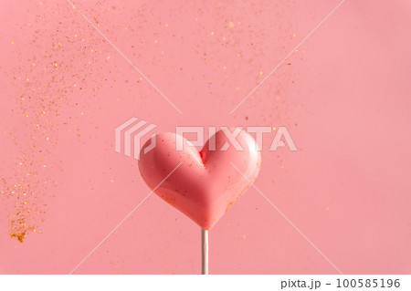 Pink Valentine's day heart shape lollipop candy on empty pastel paper background. Love Concept 100585196