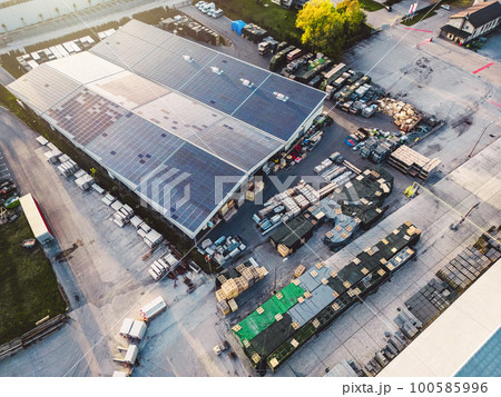 Top down view solar panels covering the roof top of large storage facility  100585996