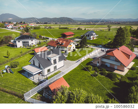 Aerial view of modern houses, family homes in the countryside with big backyards Aerial view of modern houses, family homes in the countryside with big backyards 100586032