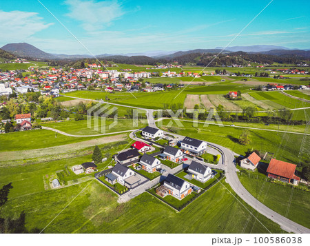 Aerial view of new housing development and the suburban community in the background Aerial view of new housing development and the suburban community in the background 100586038