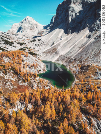Vertical photo of fantastic mountain lake in Triglav national park with scree slopes under mountain tops surrounding the lake Vertical photo of fantastic mountain lake in Triglav national park with scree slopes under mountain tops surrounding the lake 100586062