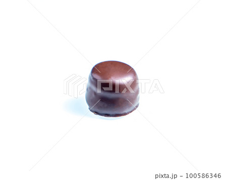 Round chocolate candy on a white background. 100586346