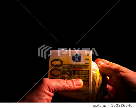 Man's hands are counting money in the dark. Man's hands are counting money in the dark. 100586646