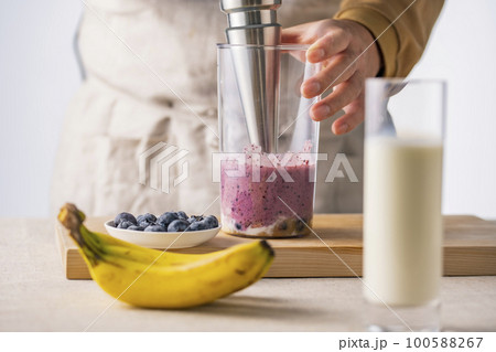 Woman preparing fresh fruit smoothie in the kitche 100588267