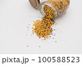 Yellow lentils and flaxseed mixed pour from the bottle 100588523