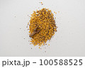 Wooden scoop with yellow lentils 100588525