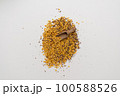 Wooden scoop with yellow lentils 100588526