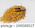 Wooden scoop with yellow lentils 100588527