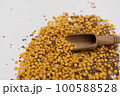 Wooden scoop with yellow lentils 100588528