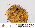 Wooden scoop with yellow lentils 100588529