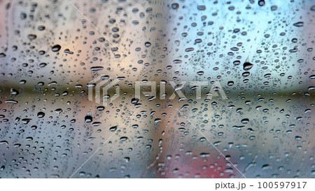 Car window glass after washing. It is covered with water droplets on the outside. Car window glass after washing. It is covered with water droplets on the outside. 100597917