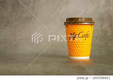 Paper cup of hot mcdonalds drink on stone table 100598801