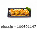spicy salmon rolls in a plastic tray on white background 100601147
