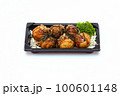 Takoyaki, mayonnaise, soy sauce, sprinkled with seaweed in a black plate on a white background. 100601148