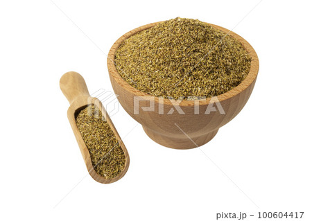 dried common chamomile flowers in latin - Matricaria chamomilla in wooden bowl and scoop isolated on white background. Medicinal herb. 100604417