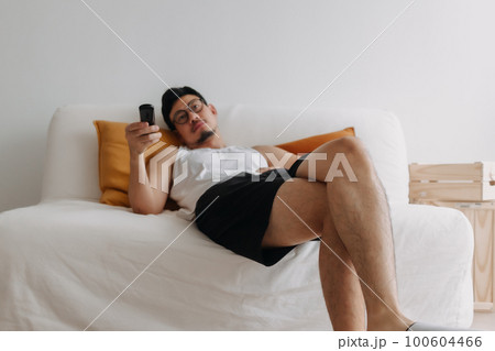 Boring life and lonely man watching tv in his living room. Boring life and lonely man watching tv in his living room. 100604466