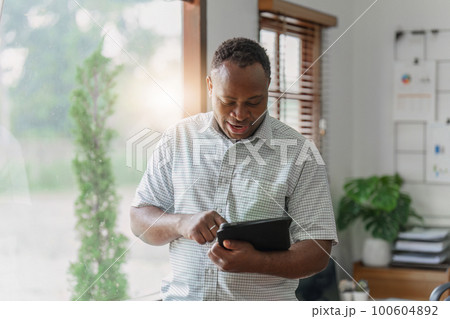 American African Businessman research and analysis with financial graph at office. Strategy, chart, finance report concept American African Businessman research and analysis with financial graph at office. Strategy, chart, finance report concept 100604892